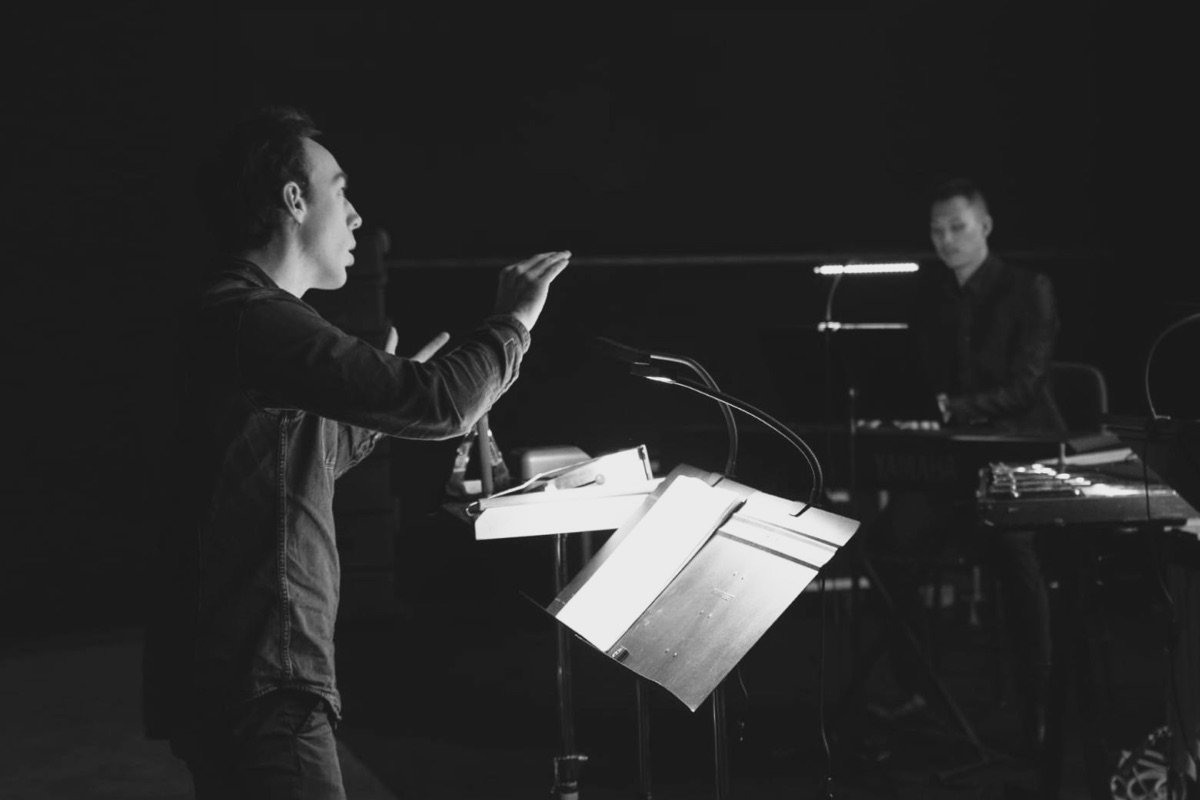 Théodore Vibert dirigeant des musiciens sur scène